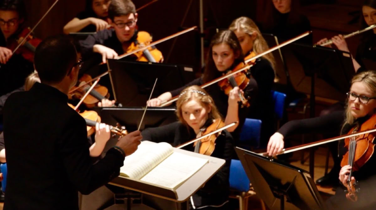 Picture of Bede Williams conducting St Andrews Chamber Orchestra in the Younger Hall